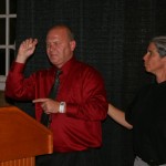 Chris Loomis relates his personal story, alongside ASL Interpreter.