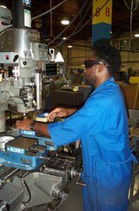 Photo of Roosevelt working in the 1990s at the Lighthouse Machine Shop